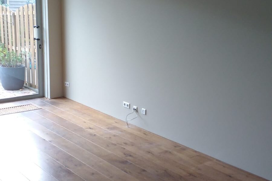 Strak afgewerkte wanden in een woning als voorbeeld van uitgevoerd werk